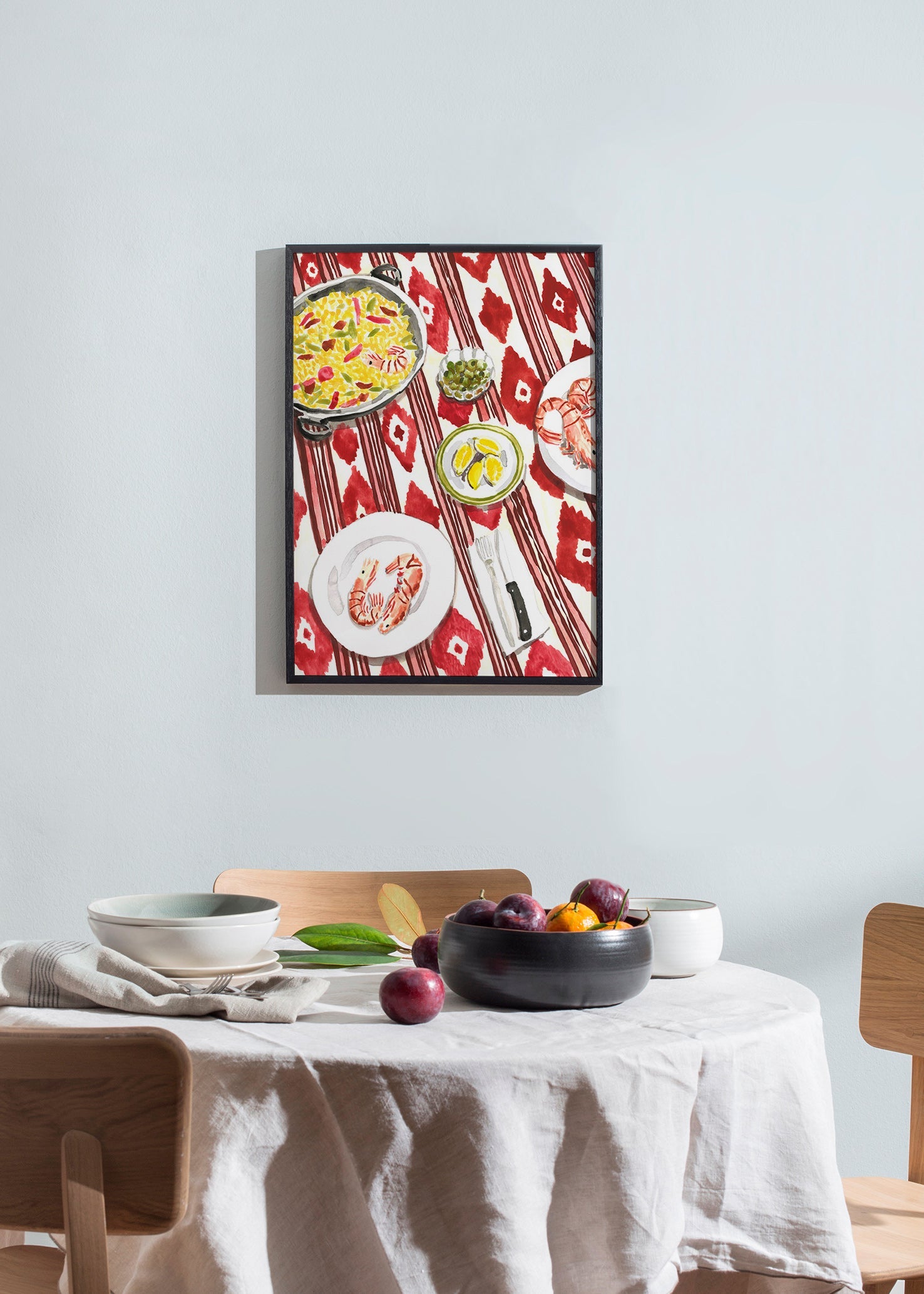Kitchen art: paella and prawns on a patterned tablecloth