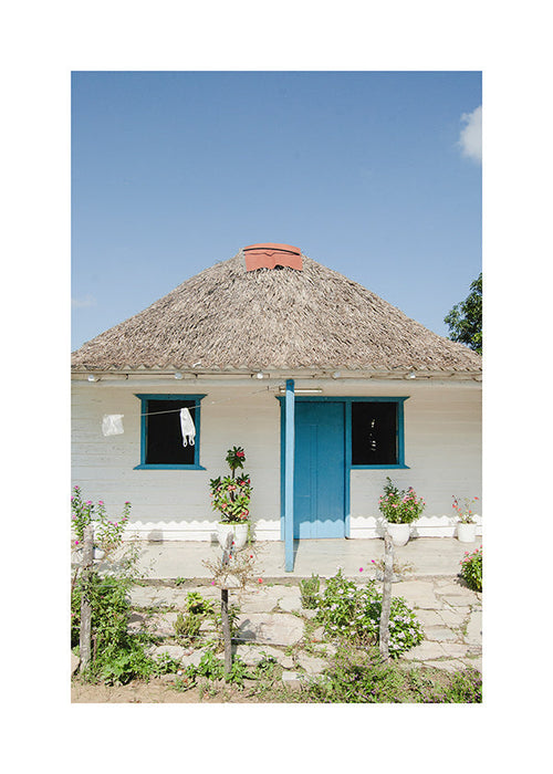 Cuadro de paisaje con casa y puerta azul