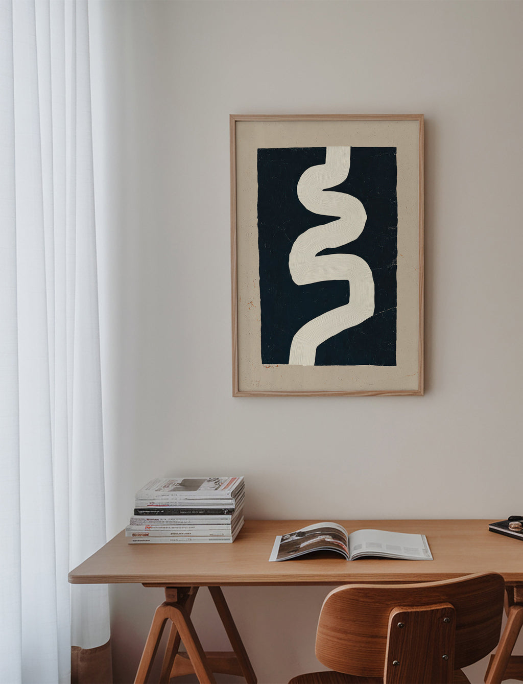 Minimalist print with a white curve on a dark panel