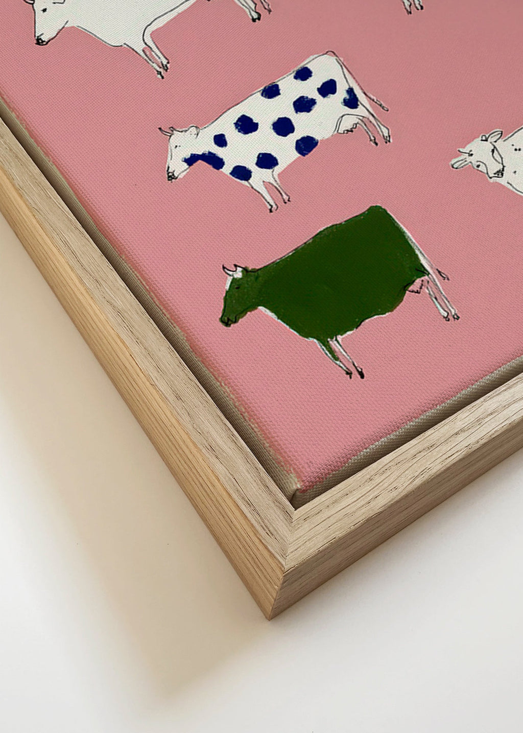 Artwork with playful cows on pink background