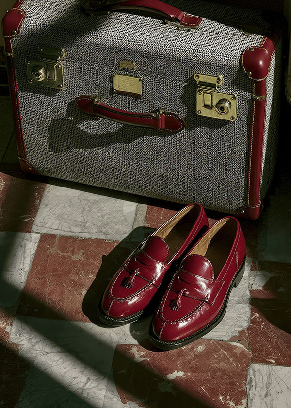 Travel photograph with vintage suitcase and red loafers